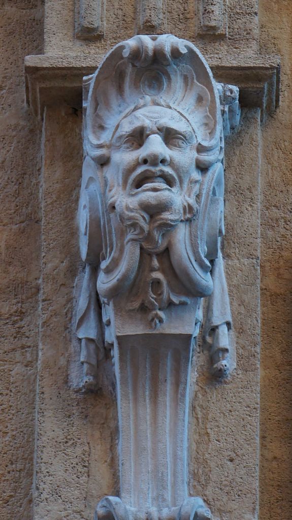 One of the many small statues on the walls of Aix-en-Provence