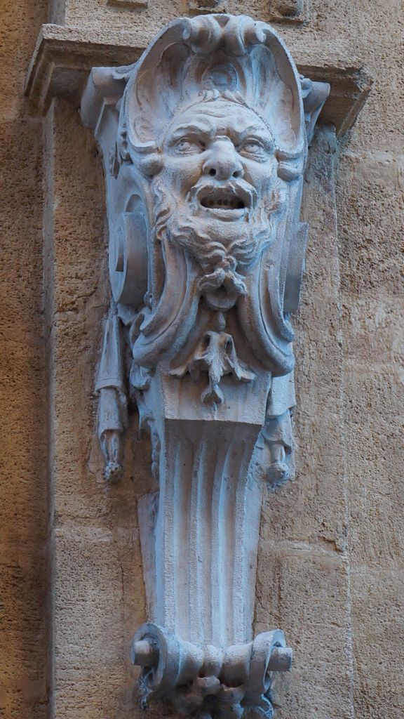 One of the many small statues on the walls of Aix-en-Provence
