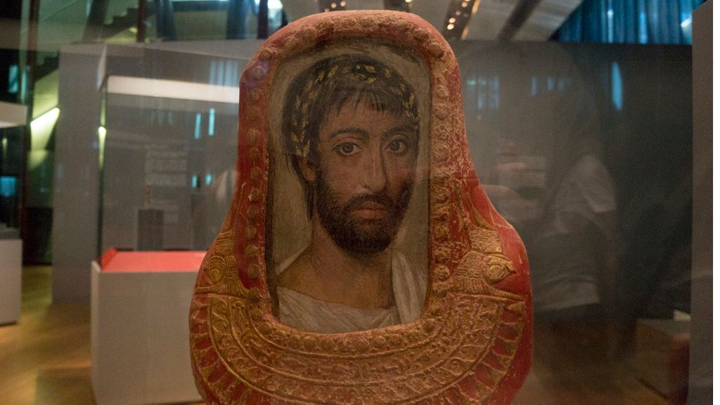 Mixture of old and new: a greek painting replacing the traditional head of an Egyptian sarcophague, Roman or Ptolemaian period, Egypt, (at a temporary exhibition at the MuCEM, in Marseille)